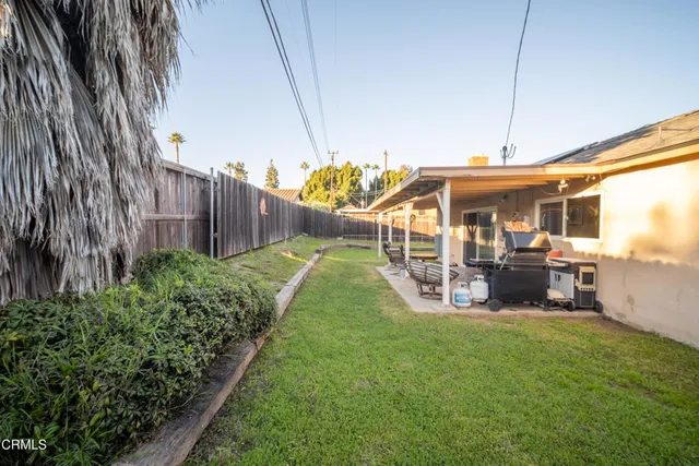 a view of a backyard with sitting area and slide