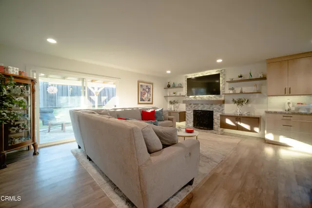 a living room with furniture a fireplace and a flat screen tv