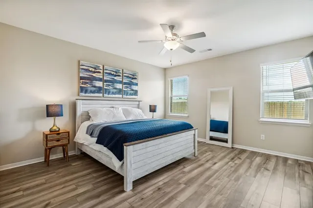 a spacious bedroom with a bed and window