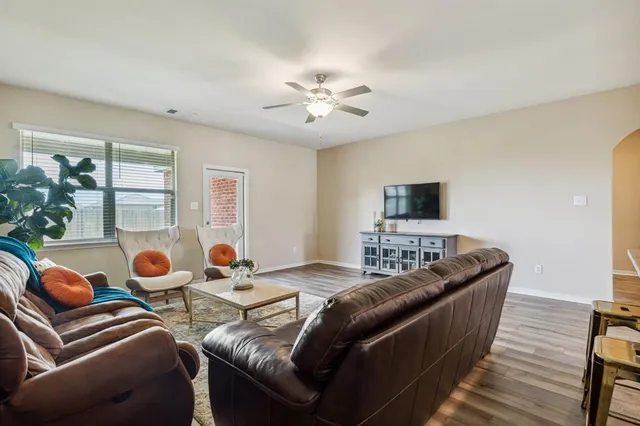 a living room with furniture and a chandelier