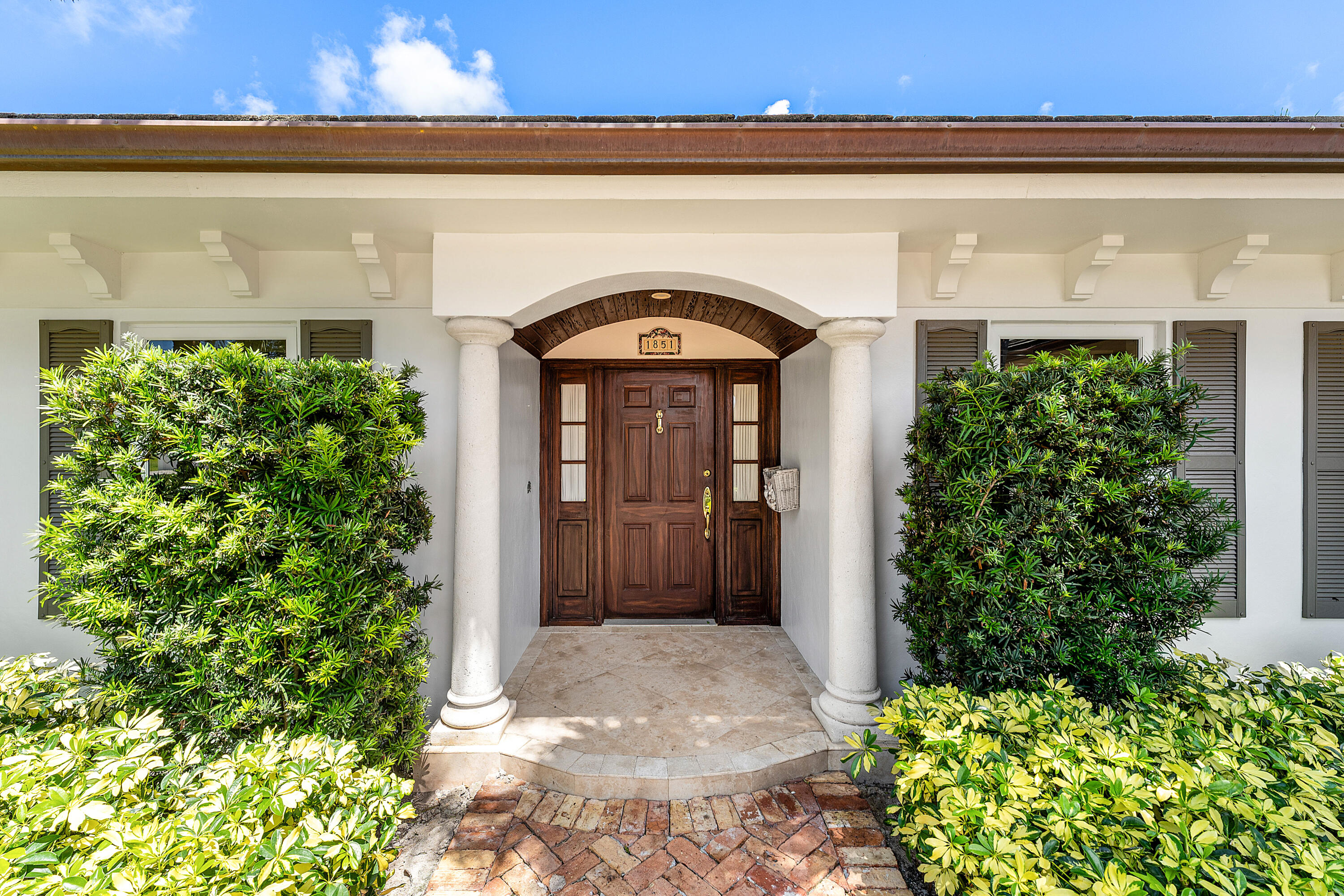 1851 Thatch Palm Drive Boca Raton, FL 33432 - Photo 6 of 70 a front view of a house with a garden