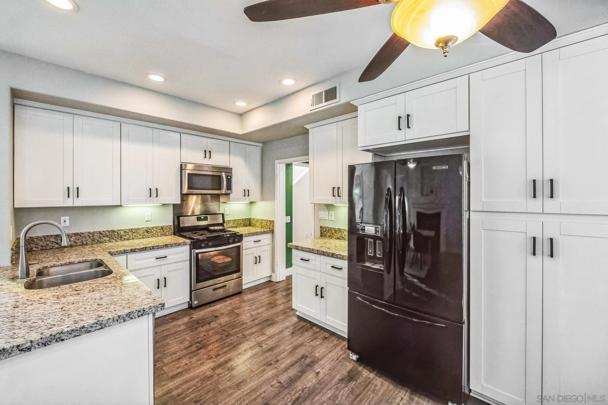 3682 Via Bernardo Oceanside, CA 92056 - Photo 11 of 30 a kitchen with granite countertop a refrigerator stove and sink