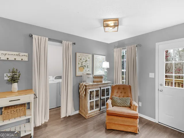 a bedroom with a bed a window and a flat screen television