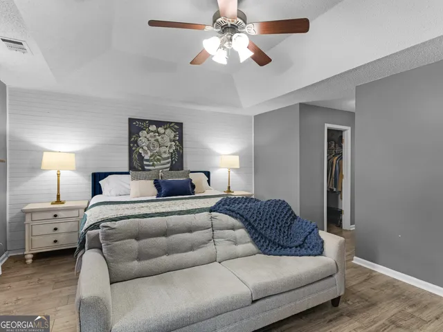 a bedroom with a bed and wooden floor