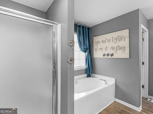 a bedroom with a bed a dresser and a window