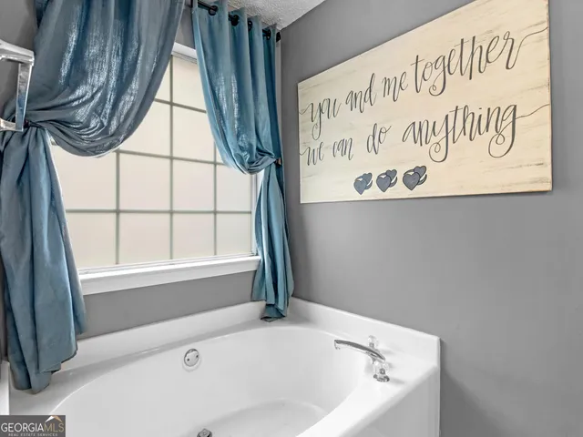 a bathroom with a toilet sink vanity and mirror
