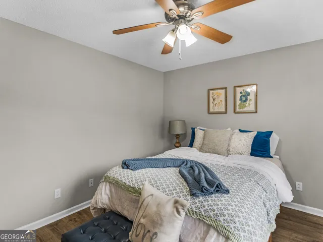 a bedroom with a bed and a dresser in it