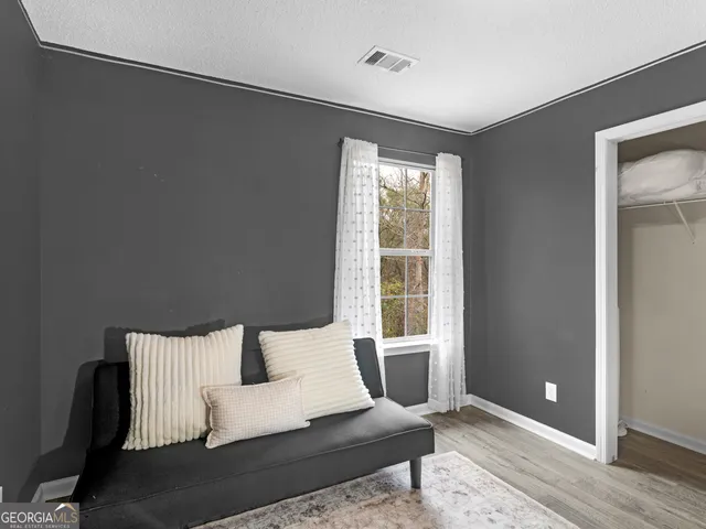 a bedroom with furniture and a wooden floor