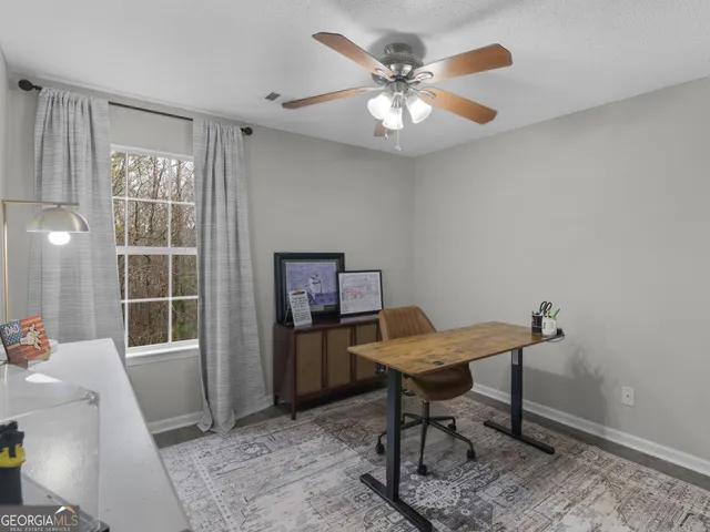 a room with furniture and screen fan