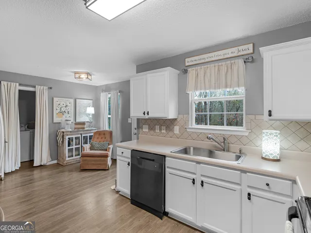 a metallic refrigerator freezer sitting in a kitchen