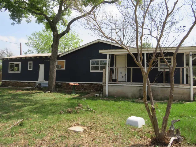a house that has a tree in front of it
