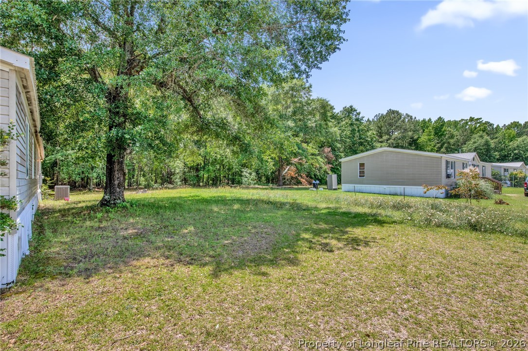 4705 Hickory Ridge Road Parkton, NC 28371 - Photo 33 of 37 a backyard of a house with lots of green space