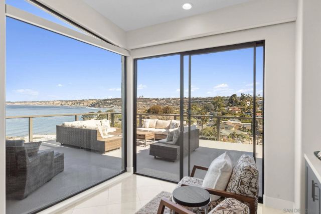 a living room with furniture and a floor to ceiling window