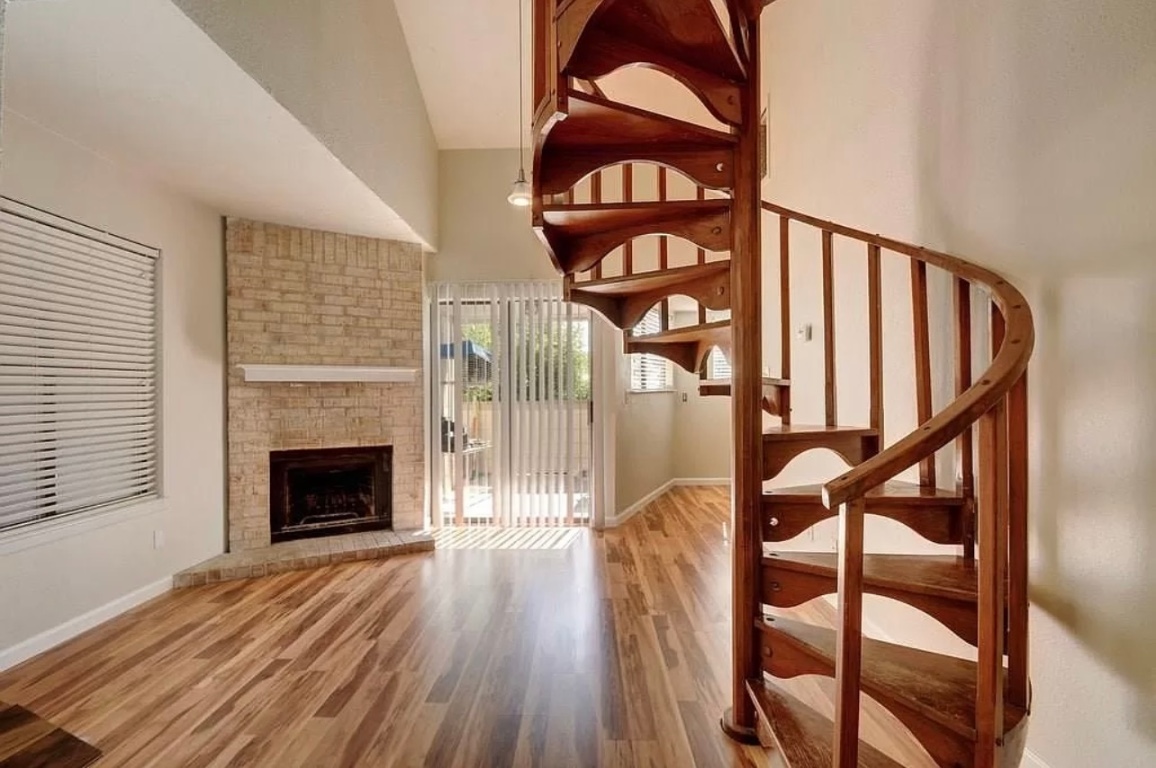 2500 Burleson Road, Unit 317 Austin, TX 78741 - Photo 2 of 12 a view of stairs and wooden floor
