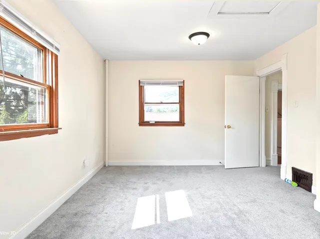 a view of a big room with windows and closet