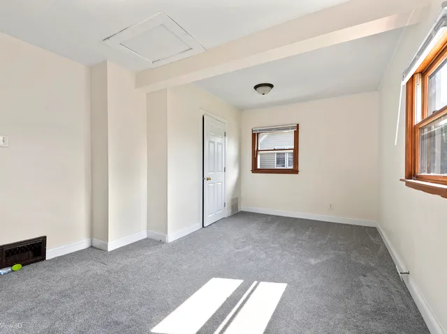 a view of room with window and wooden floor