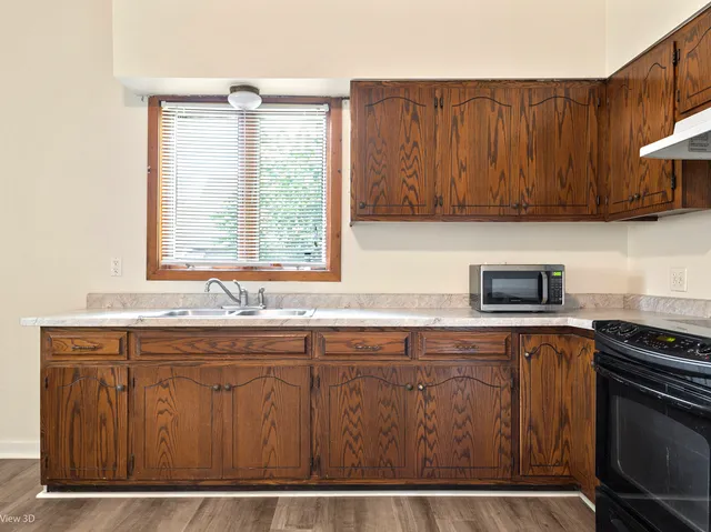 a kitchen with a refrigerator and a sink