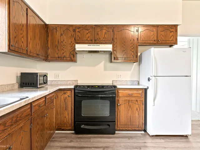 a kitchen with stainless steel appliances granite countertop a refrigerator stove and sink