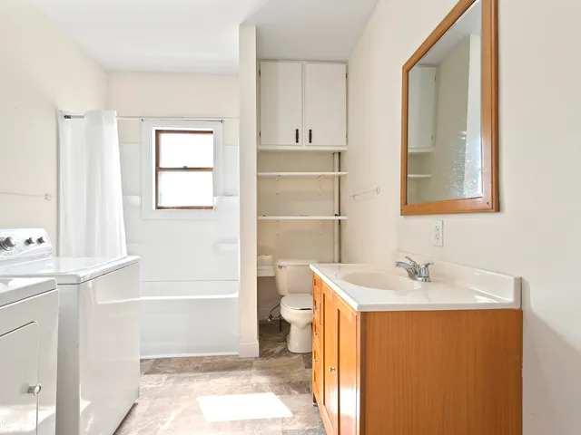 a white toilet sitting next to a bathroom sink