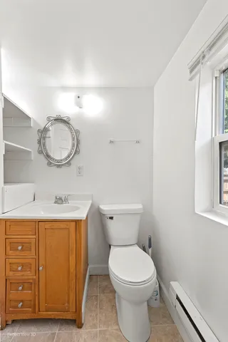 a bathroom with a granite countertop sink a mirror and a shower