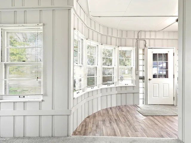 a view of an entryway with wooden floor and a cabinet