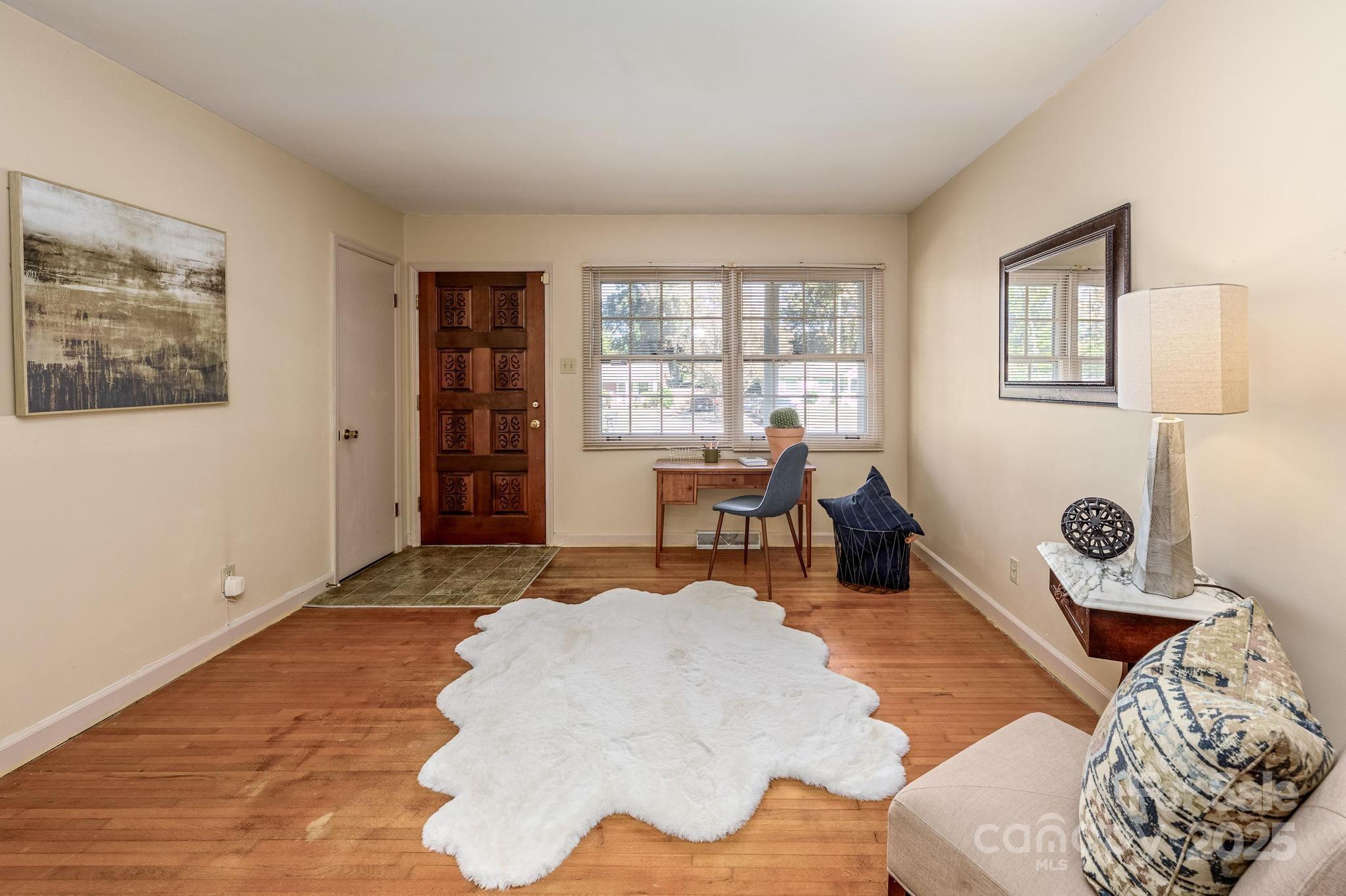 4314 Ivanhoe Place, Unit 26 Charlotte, NC 28205 - Photo 2 of 25 a bedroom with furniture and a large window