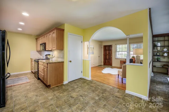 a view of kitchen with furniture and refrigerator