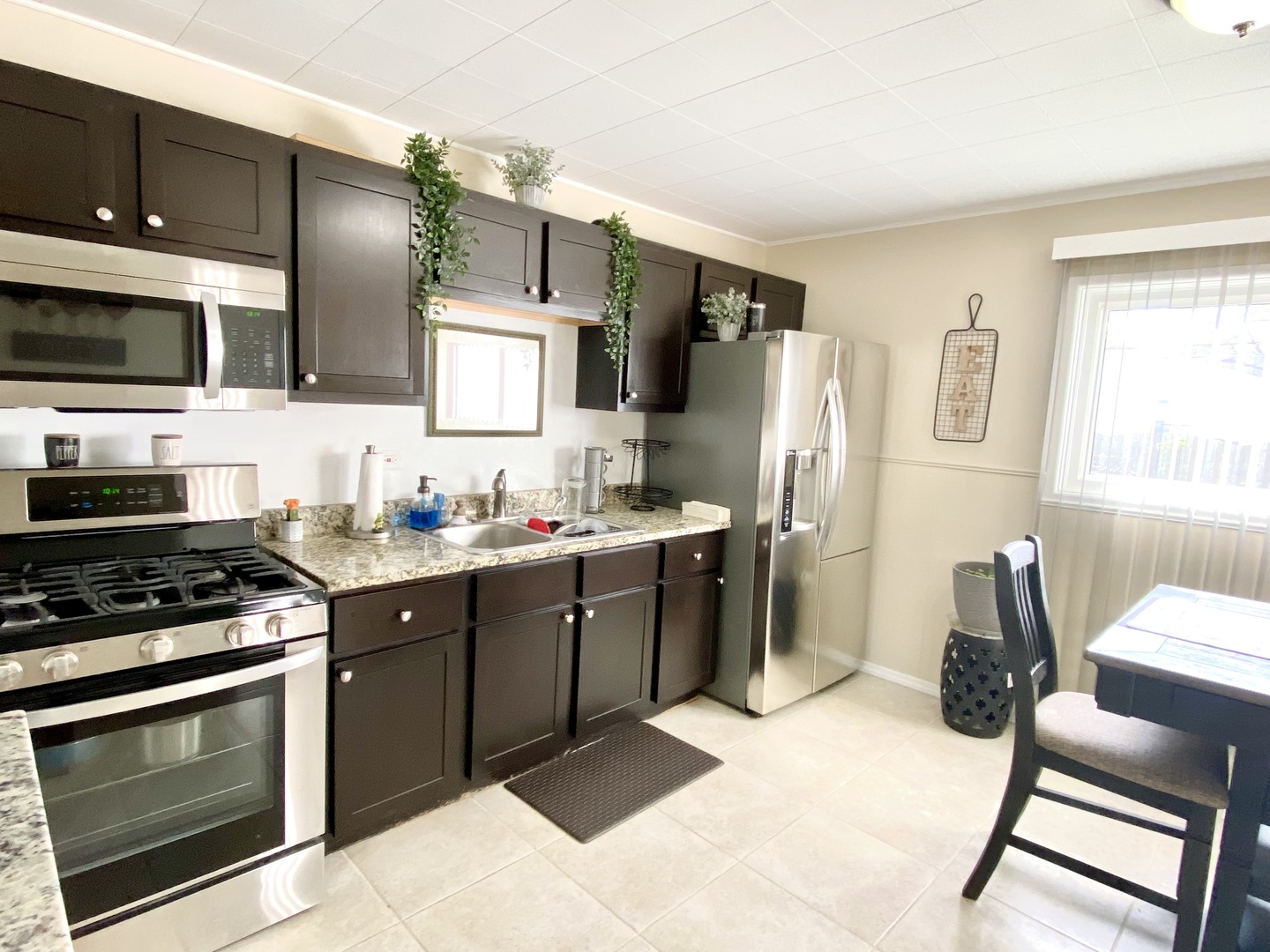 21 Dover Avenue Romeoville, IL 60446 - Photo 8 of 22 a kitchen with a sink cabinets and stainless steel appliances