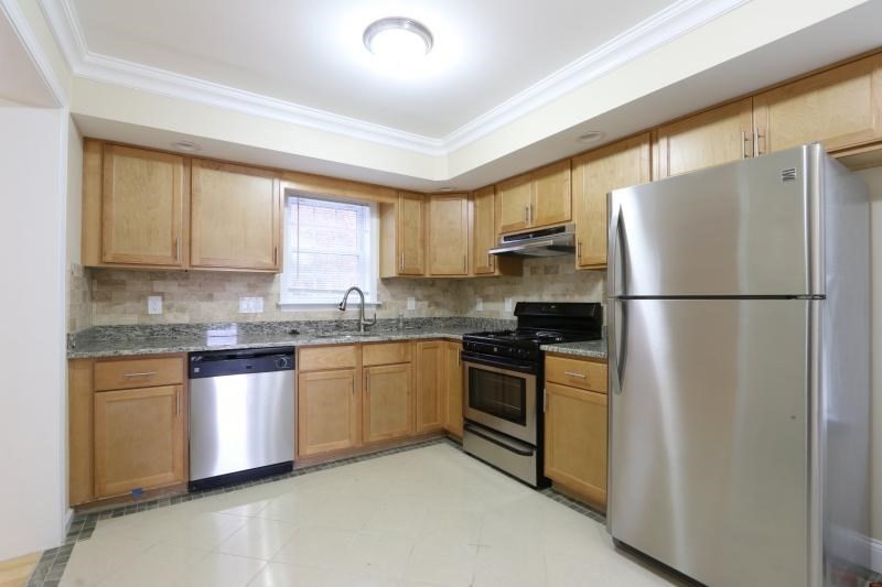 a kitchen with granite countertop stainless steel appliances a refrigerator a sink a stove a microwave and cabinets