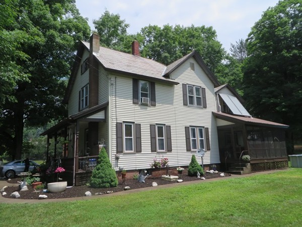 258 Main Road Colrain, MA 01340 - Photo 2 of 29 a front view of a house with a garden and yard
