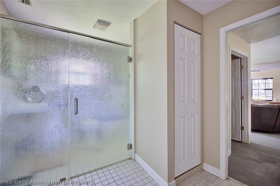 3601 Divot Road Sebring, FL 33872 - Photo 23 of 31 a bathroom with a glass shower door