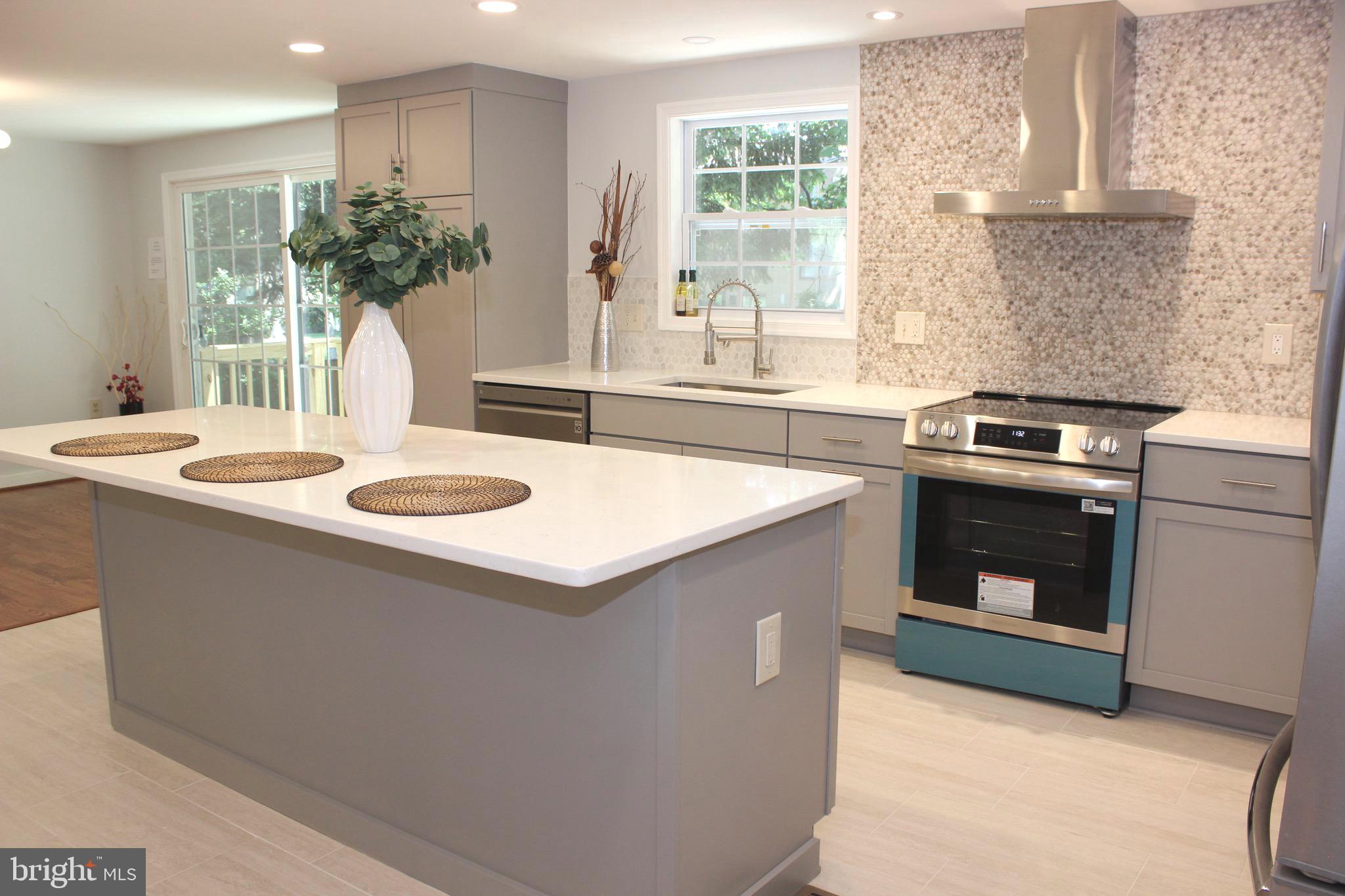 2283 Dosinia Court Reston, VA 20191 - Photo 4 of 28 a kitchen with a sink stove and cabinets