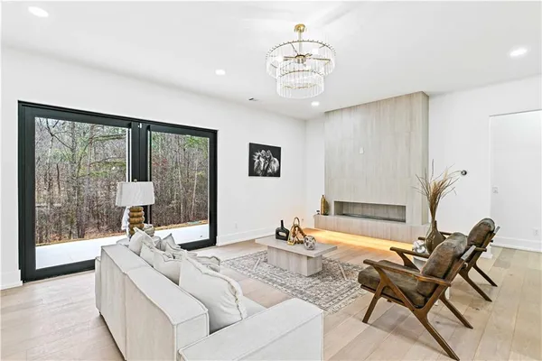 a kitchen with stainless steel appliances kitchen island granite countertop a refrigerator a stove and a sink with wooden floor
