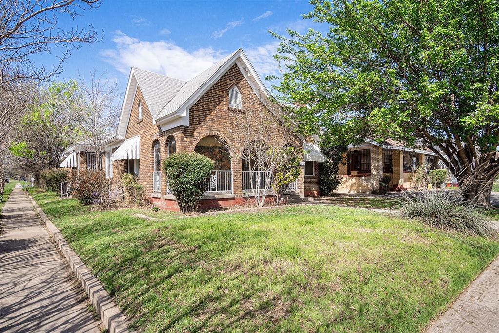 a view of a house with a yard and sitting area