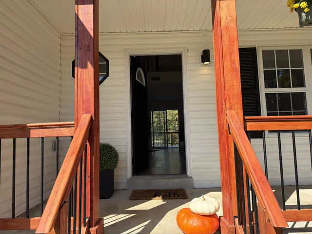 a kitchen with stainless steel appliances a sink a stove a microwave a refrigerator a window and cabinets