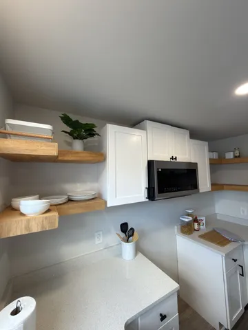 a bathroom with a double vanity sink mirror and toilet