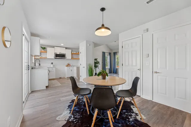 a view of staircase with a fireplace and wooden floor