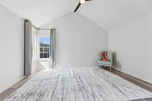 a view of wooden floor and windows in a room