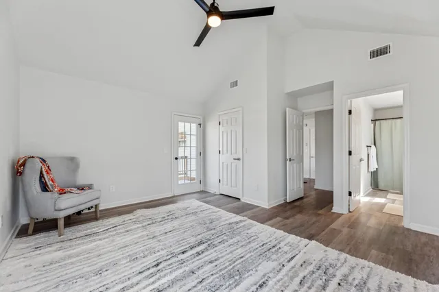 an empty room with wooden floor & closet area