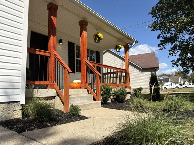 a view of a house with a small yard and plants