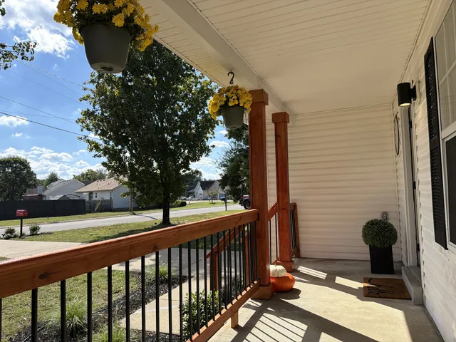 a view of a livingroom with wooden floor and a fireplace