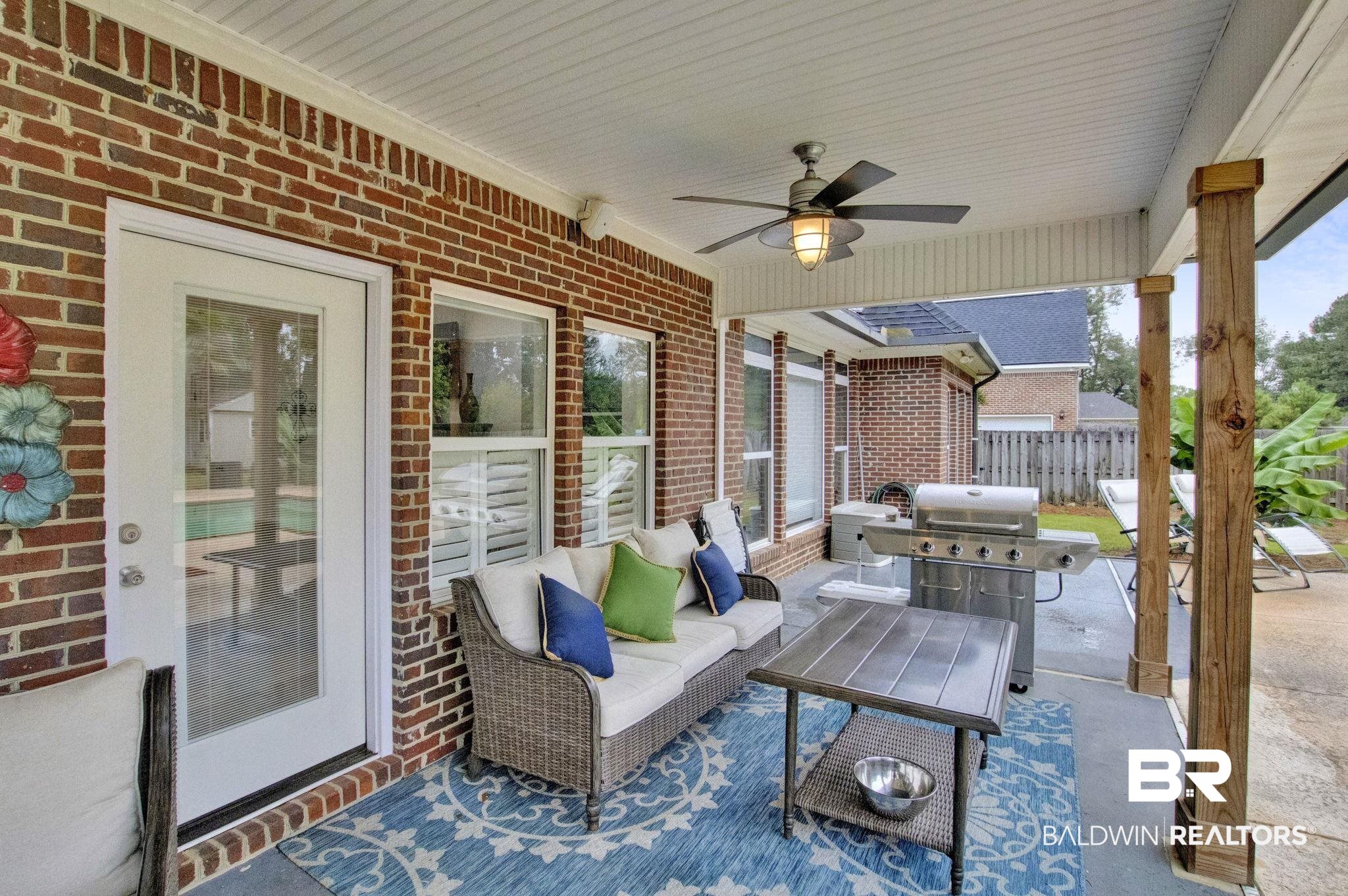 9002 Parliament Circle Daphne, AL 36526 - Photo 69 of 73 View of covered patio with grilling area, an outdoor hangout area, and ceiling fan