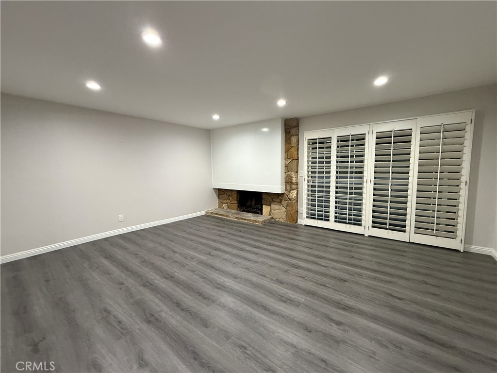 19312 Gunlock Avenue Carson, CA 90746 - Photo 12 of 44 an empty room with wooden floor and windows
