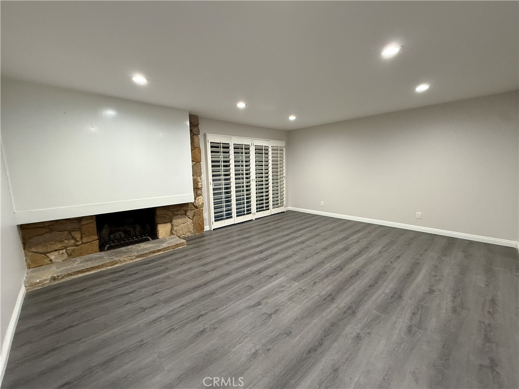19312 Gunlock Avenue Carson, CA 90746 - Photo 13 of 44 an empty room with wooden floor and windows