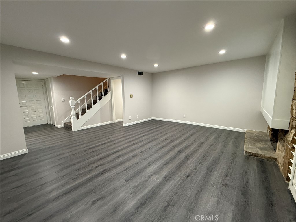 19312 Gunlock Avenue Carson, CA 90746 - Photo 15 of 44 a view of an empty room with wooden floor and a fireplace