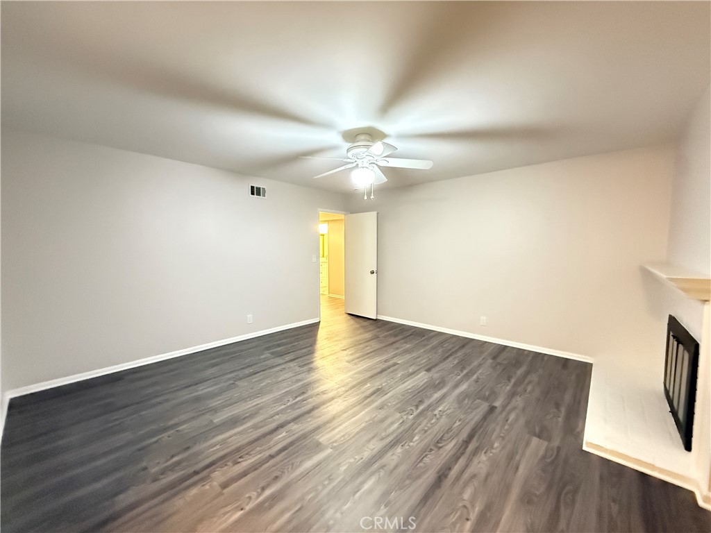 19312 Gunlock Avenue Carson, CA 90746 - Photo 19 of 44 a view of an empty room with wooden floor and a window