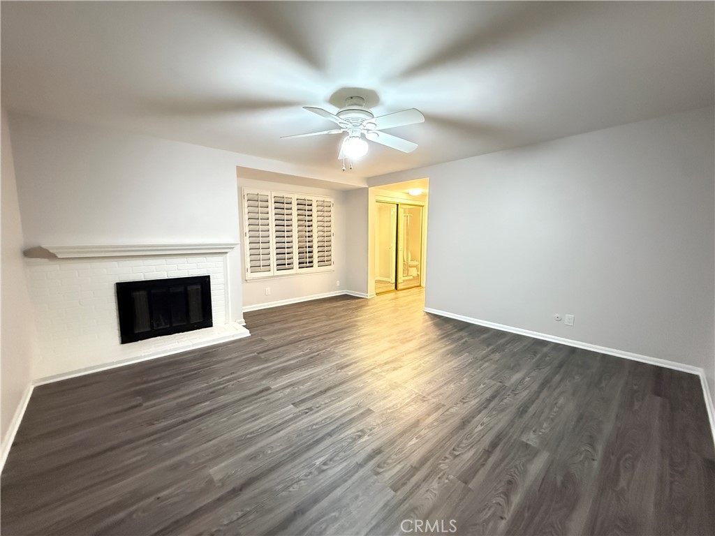 19312 Gunlock Avenue Carson, CA 90746 - Photo 20 of 44 a view of an empty room with wooden floor fireplace and a window