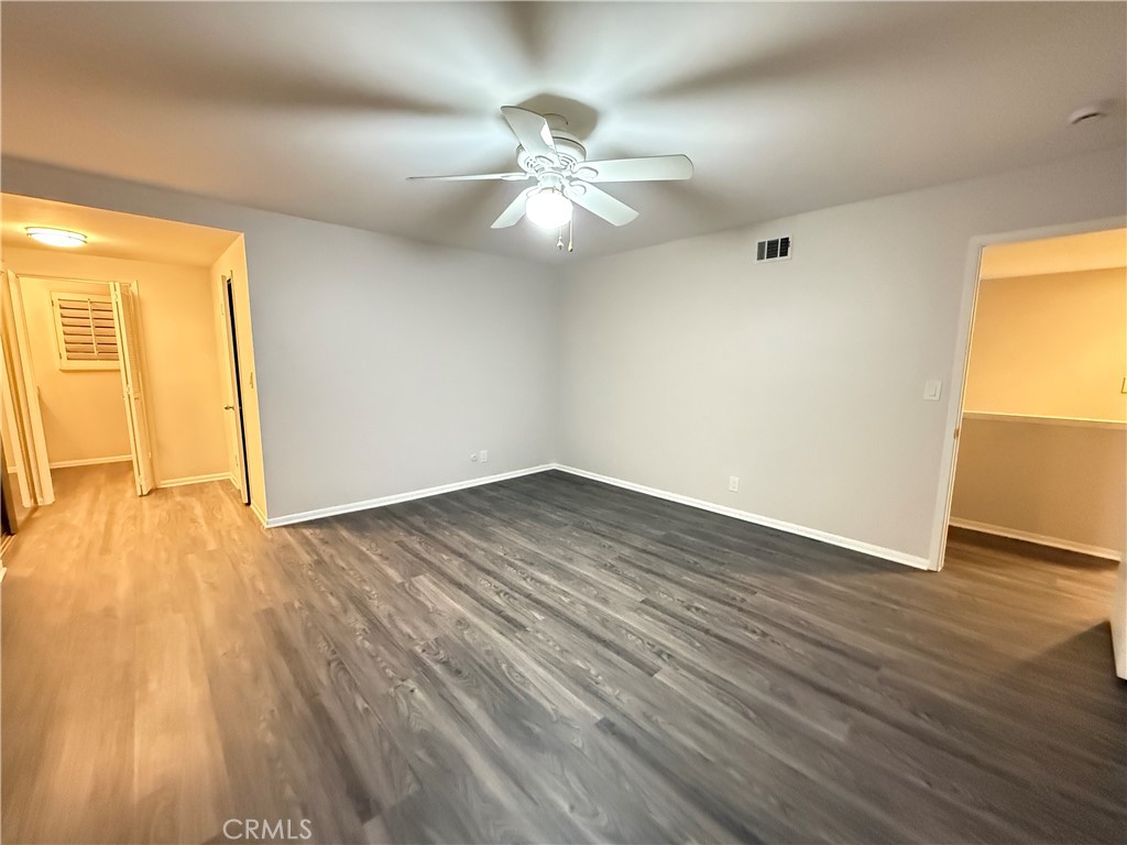 19312 Gunlock Avenue Carson, CA 90746 - Photo 28 of 44 an empty room with wooden floor and windows