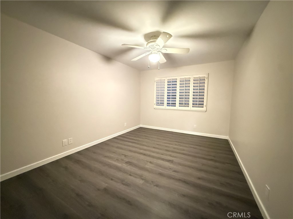 19312 Gunlock Avenue Carson, CA 90746 - Photo 29 of 44 an empty room with wooden floor fan and windows