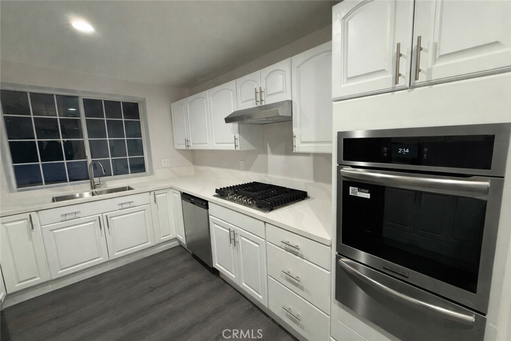 19312 Gunlock Avenue Carson, CA 90746 - Photo 3 of 44 a kitchen with white cabinets stainless steel appliances and sink